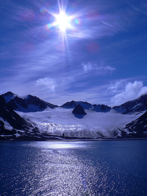 The sun above Magdalenefjorden, a beautiful fjord in Svalbard Archipelago